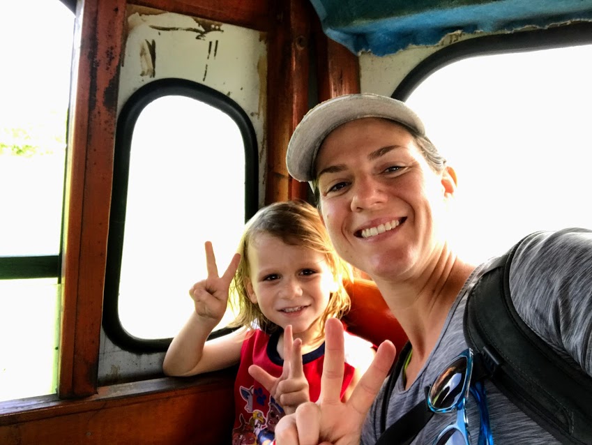 Mom and son riding aiga bus