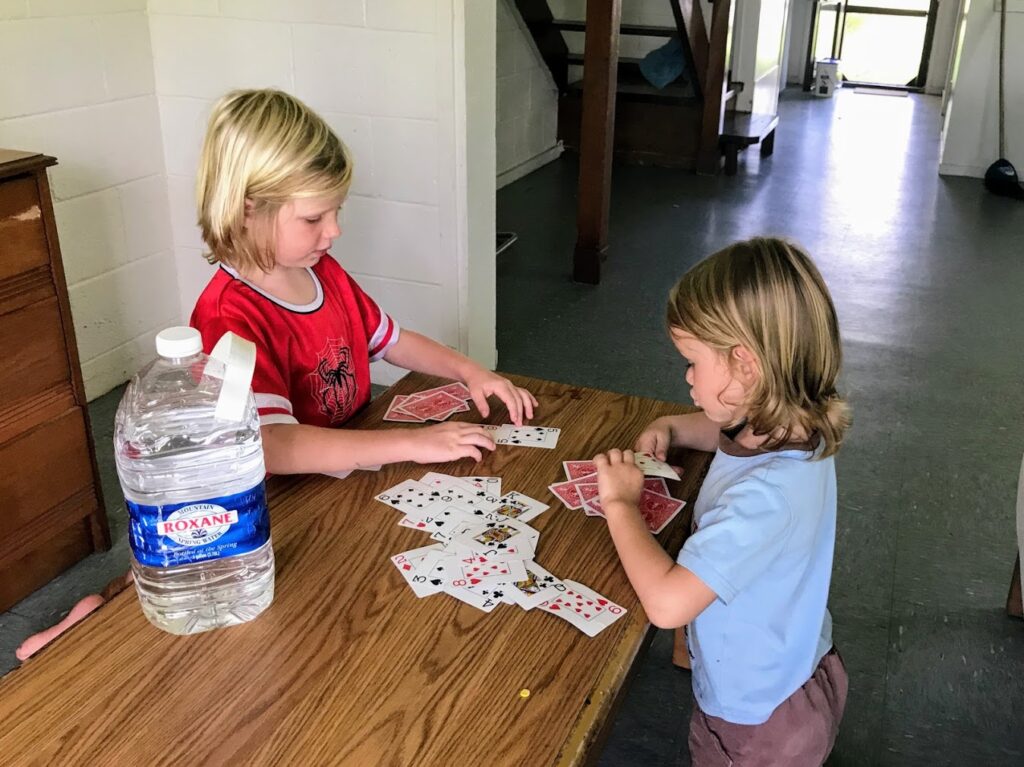 Two Young Boys Playing Cards